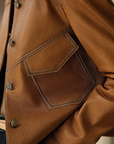 Women's brown leather jacket with collar and front pockets