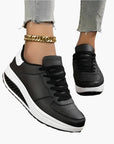 Women's orthopedic sneakers in black with supportive air cushion footbed