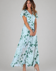 Woman wearing a floral dress on a plain background