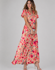 Woman wearing a floral dress on a gray background
