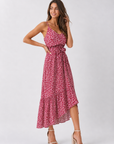 Woman wearing a pink floral dress on a white background