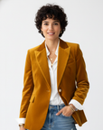 Women's green velvet blazer with gold-tone buttons