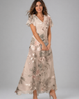 Woman wearing a floral dress on a gray background