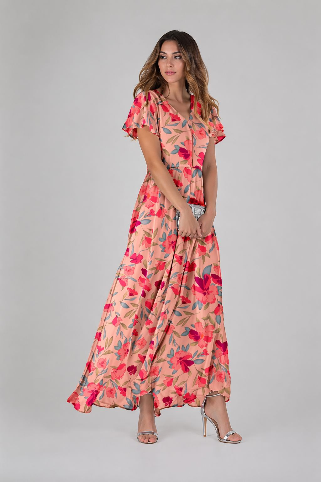 Woman wearing a floral dress on a gray background