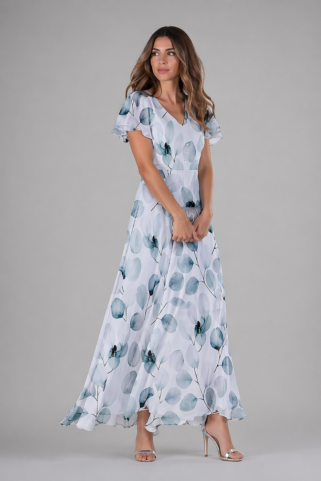 Woman wearing a floral dress on a gray background