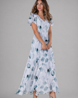 Woman wearing a floral dress on a gray background