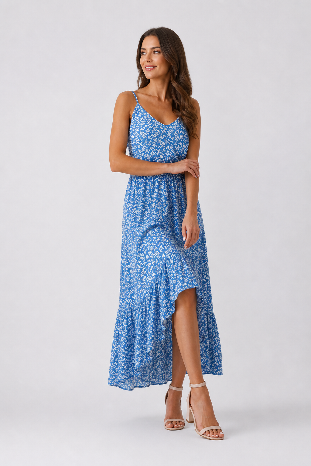 Woman wearing a blue floral dress on a white background