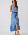 Woman wearing a blue floral dress on a white background