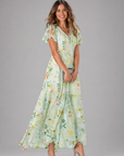 Woman wearing a floral dress on a gray background