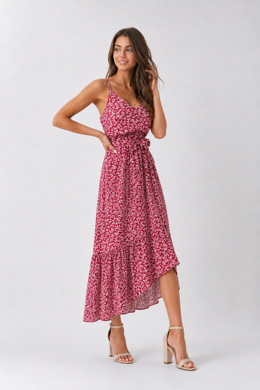 Woman wearing a pink floral dress on a white background